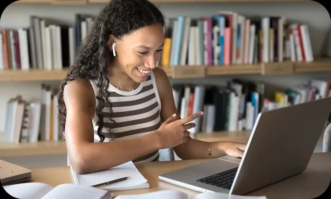 Woman participating in an online tutoring session from her home office, using her laptop.